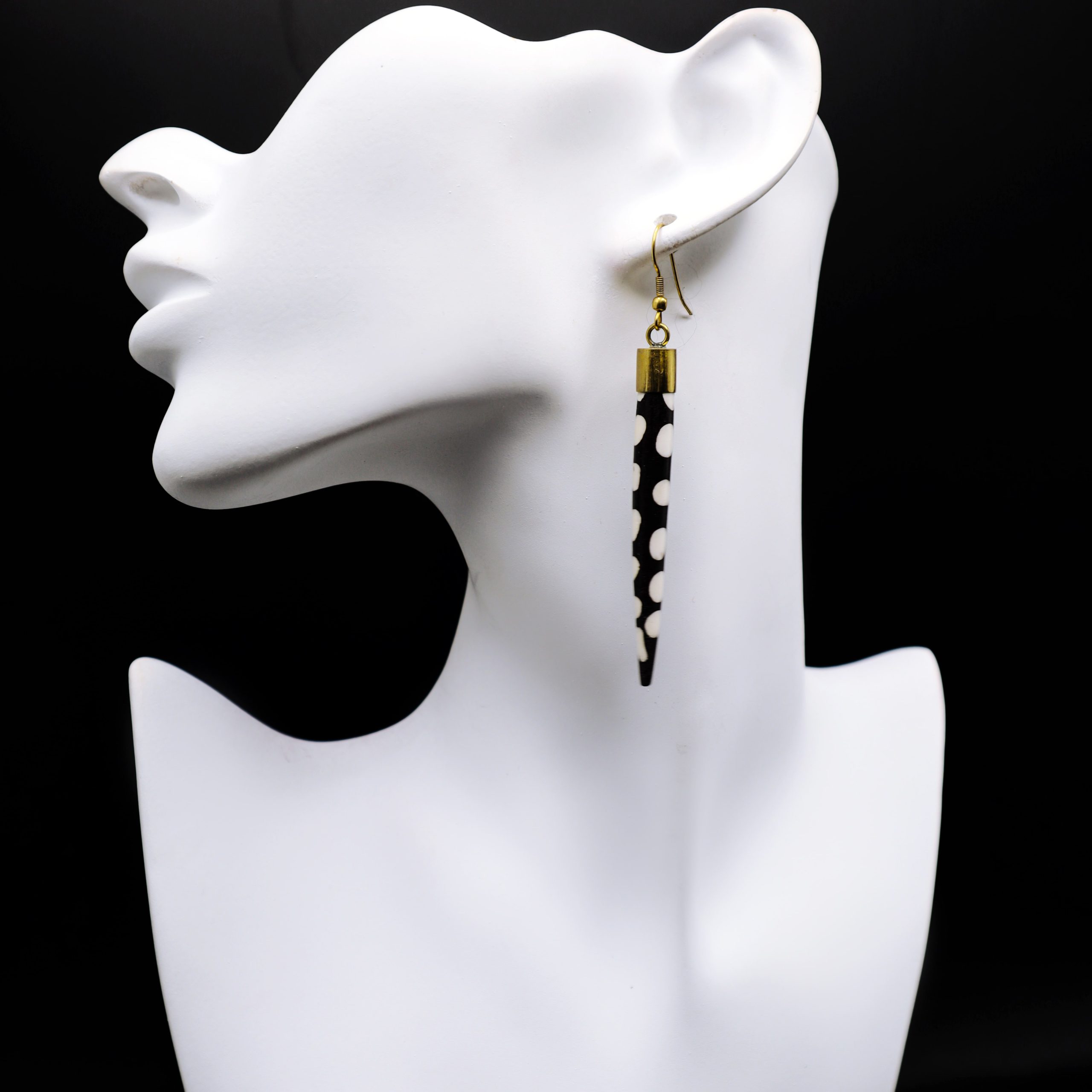 Slim conical shaped polka dotted bone earrings